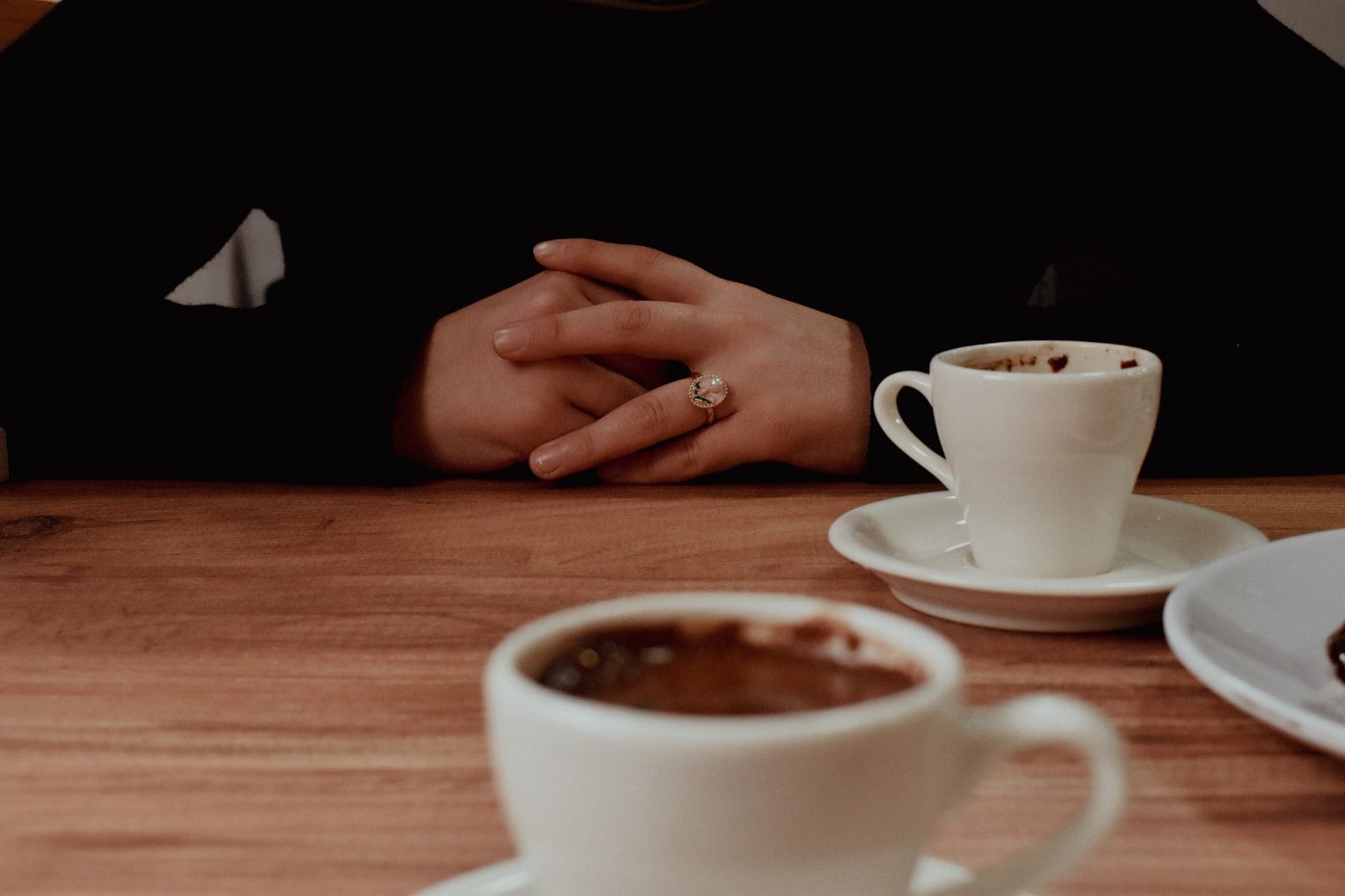 A quiet table for two with coffee, one person waiting